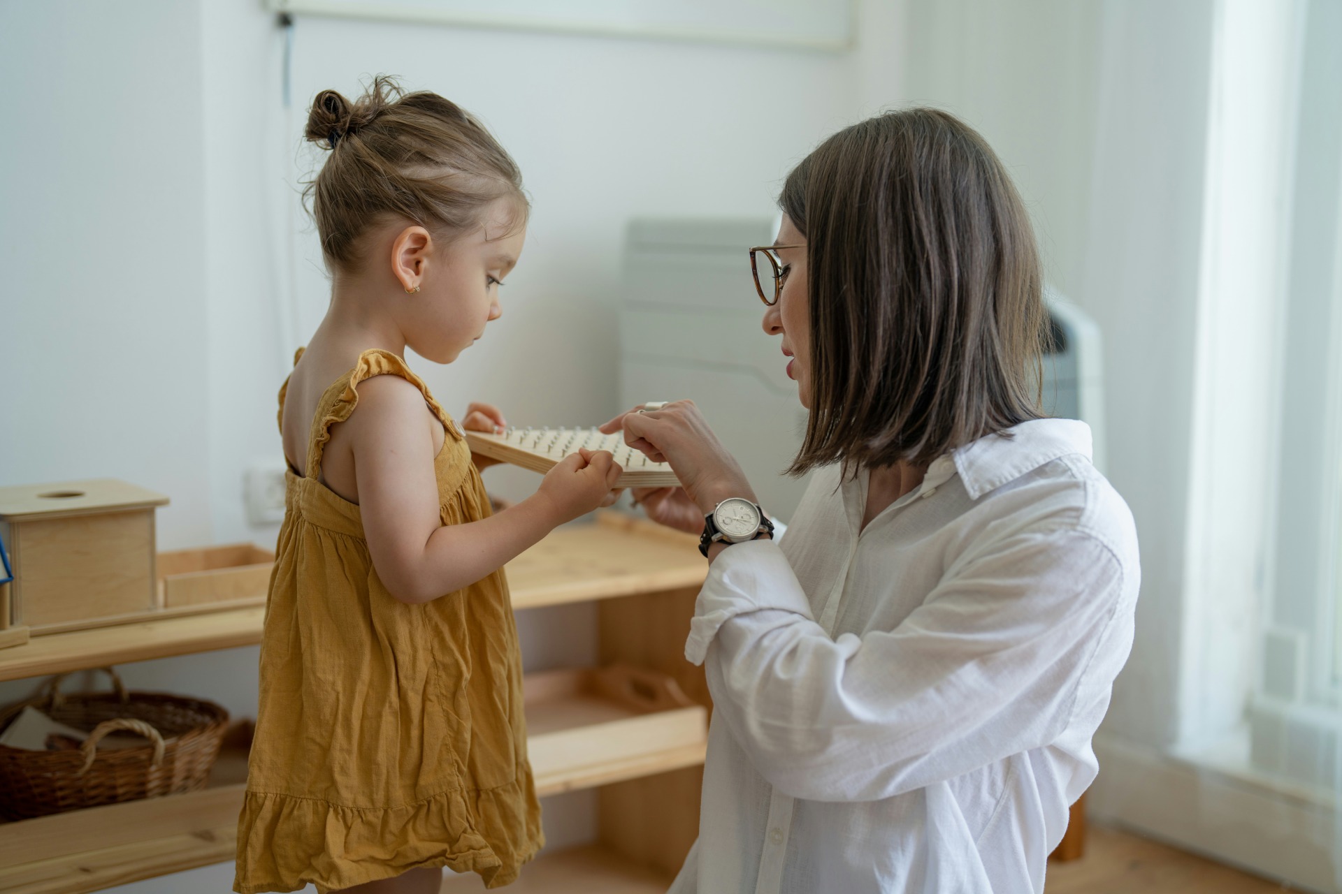 Teacher showing instrument to young child