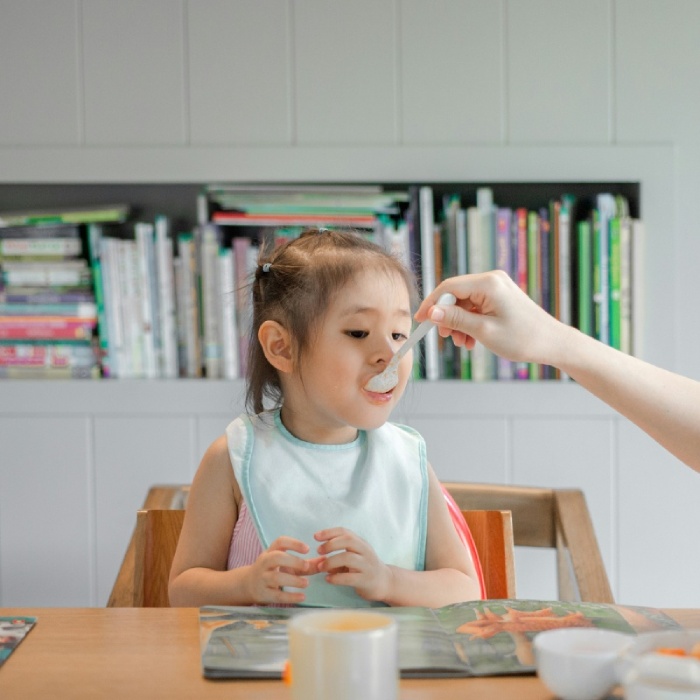 Feeding a child at the dining table