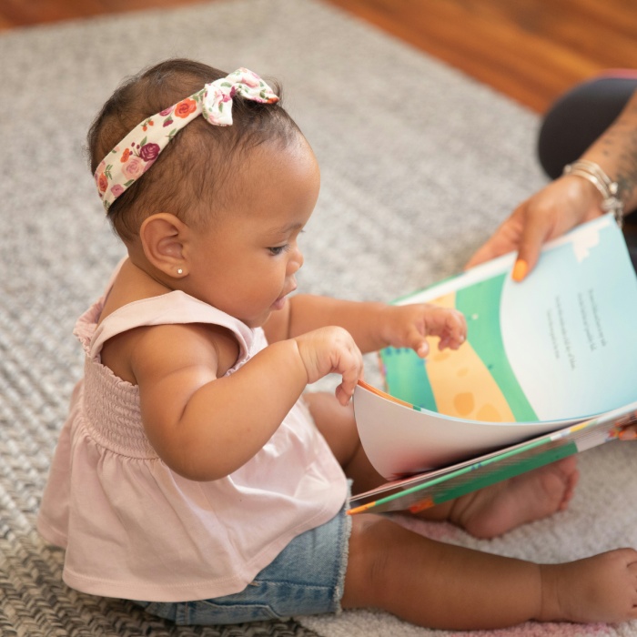 Baby intently flipping through a picture book