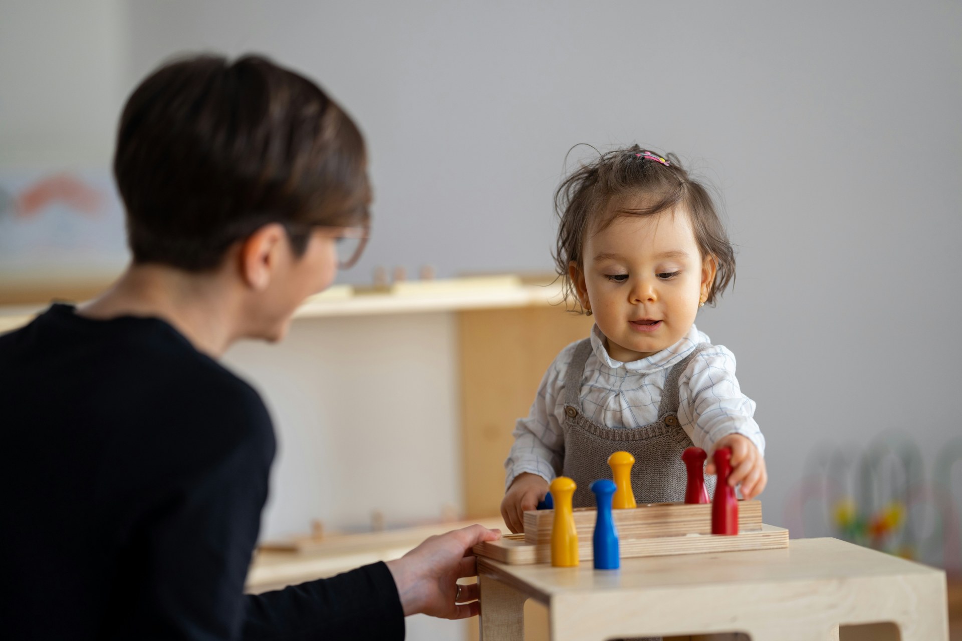 Toddler learning through colorful wooden toys