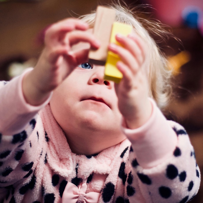Baby reaching out for wooden blocks